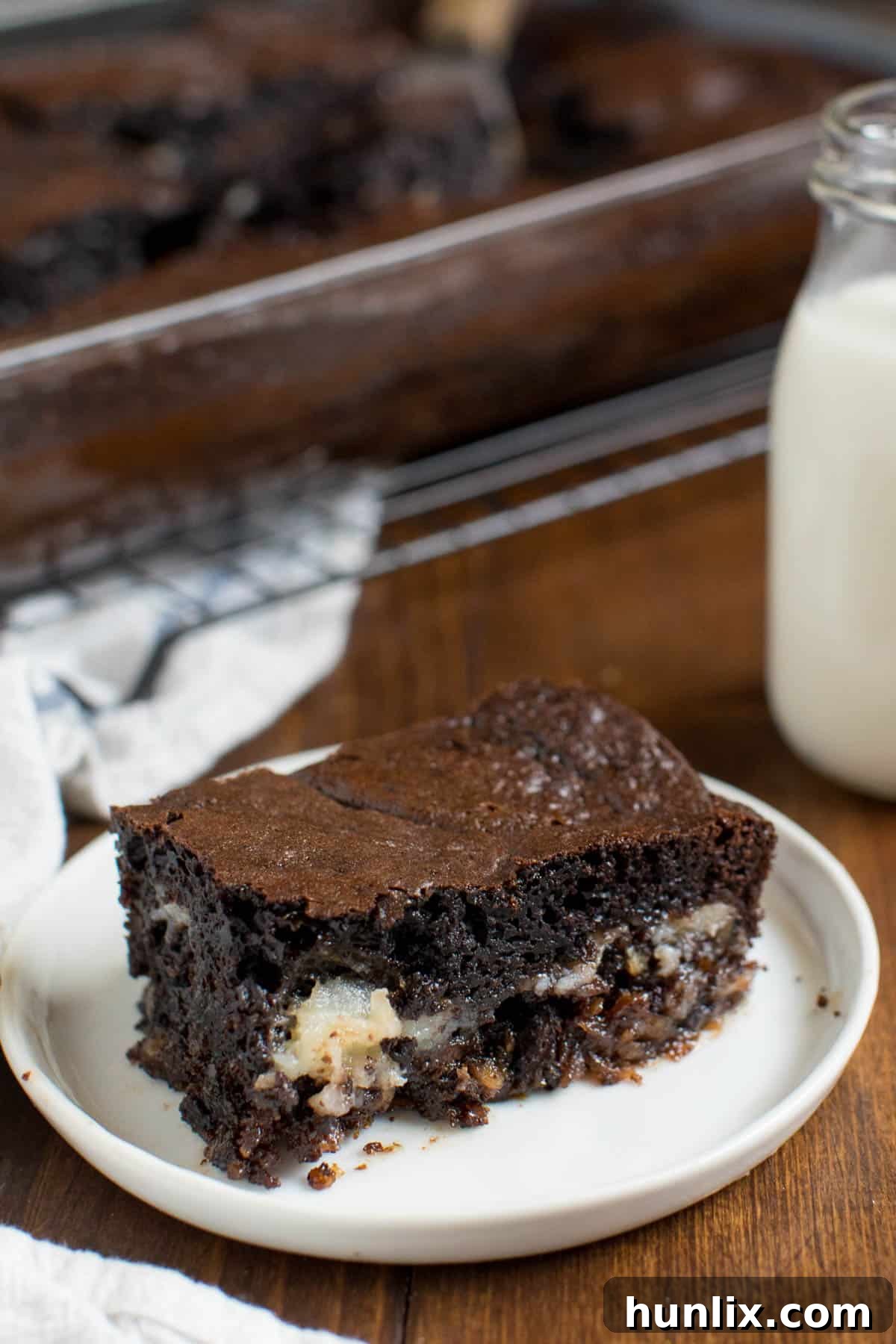 A piece of earthquake cake on a white plate, showing its rich, gooey texture.