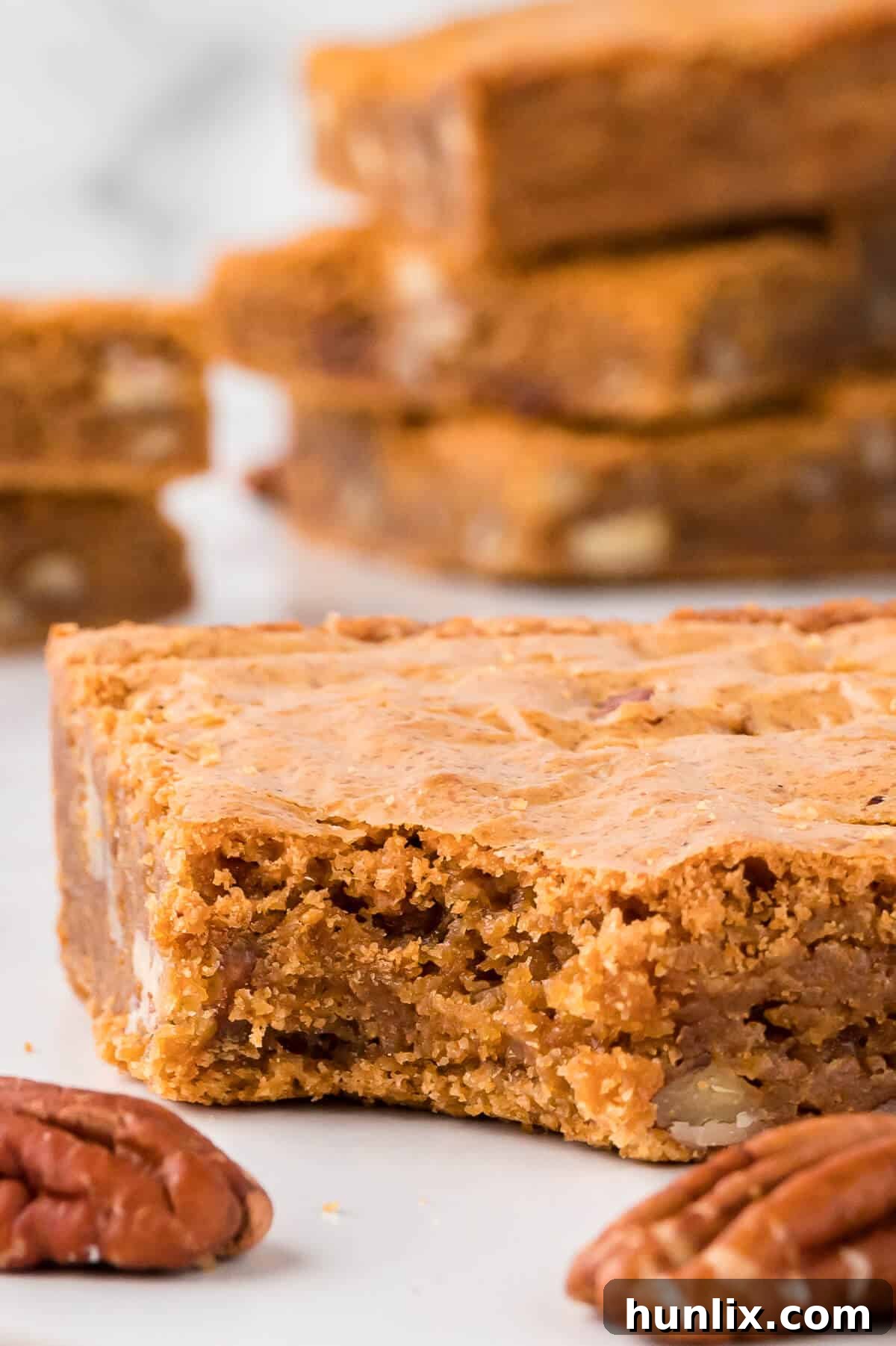 A close-up of a Penuche square with a bite taken out, revealing its rich, chewy interior.