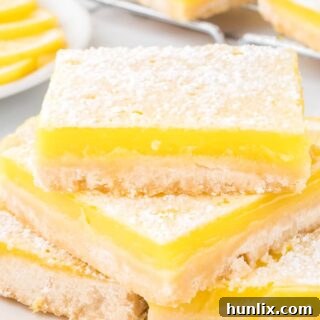 A stack of golden lemon bars, ready to be served.