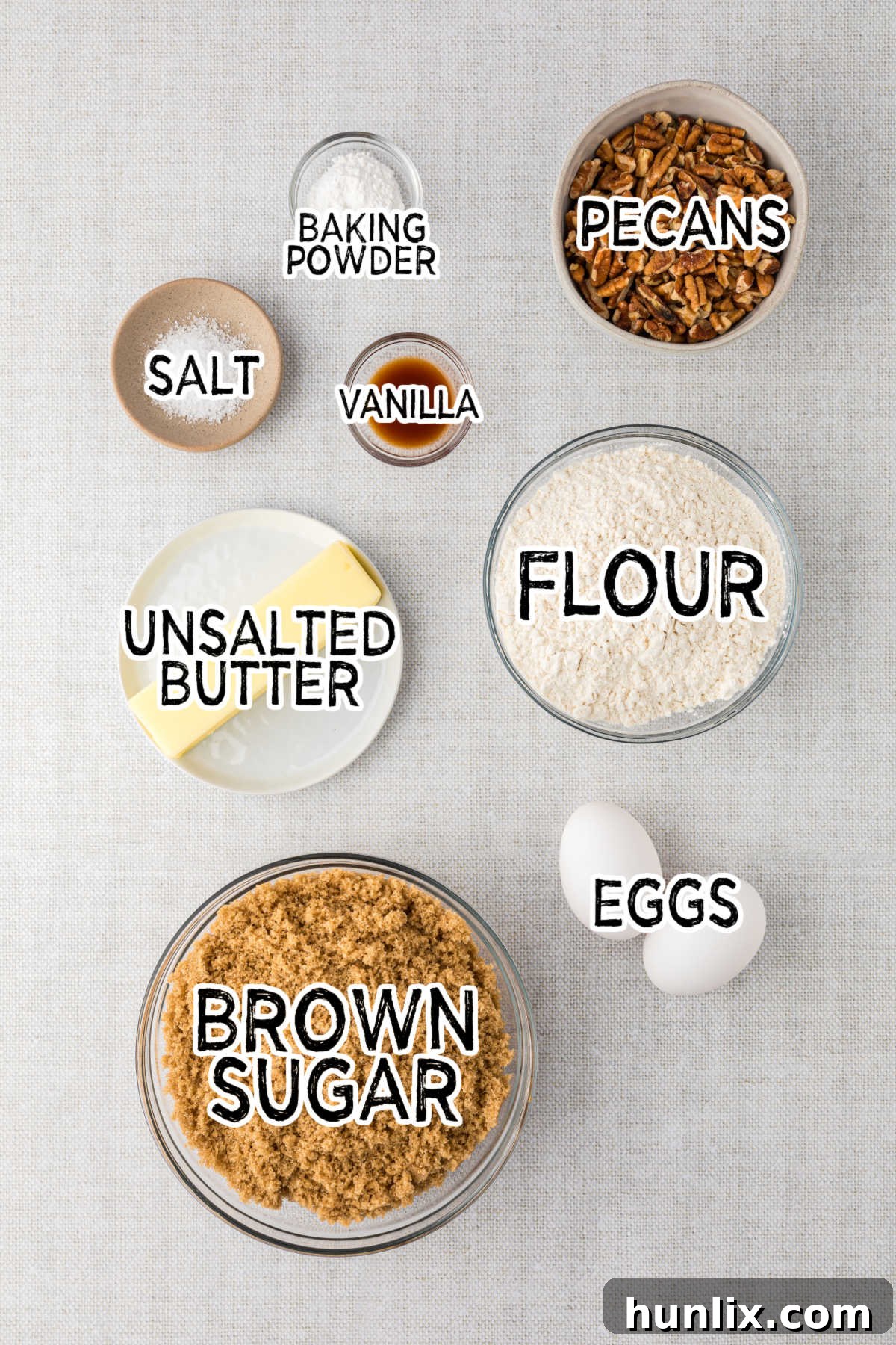 All the essential ingredients for butterscotch blondies neatly laid out on a beige surface, ready for baking.
