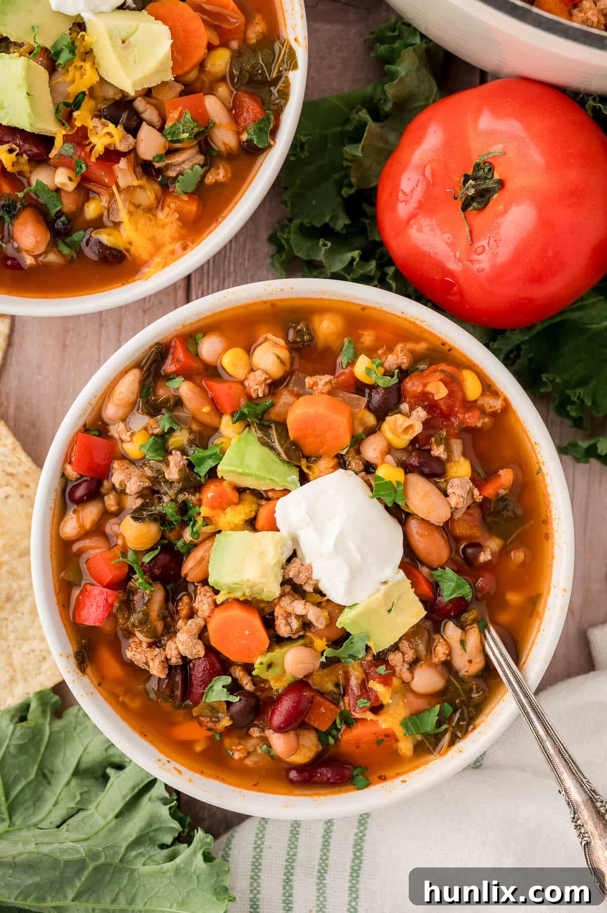 A bowl of southwestern turkey 5 bean chili, topped and ready to eat.