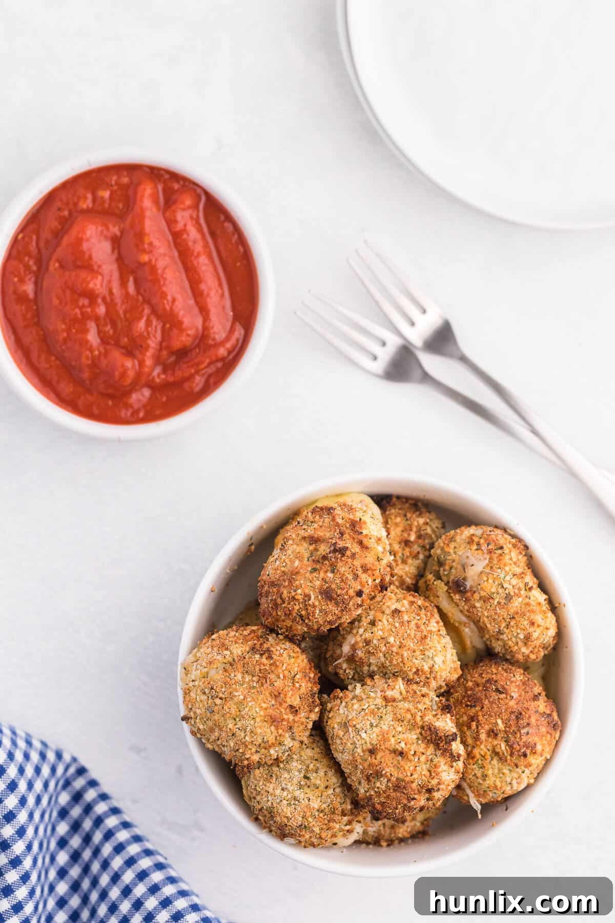 A bowl of crispy air fryer mozzarella balls, golden brown and ready to serve.