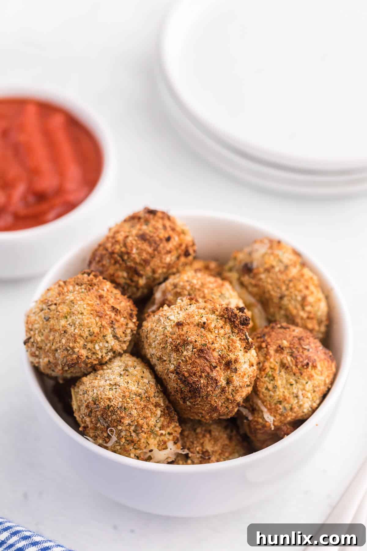Ingredients for making air fryer mozzarella balls arranged in bowls.