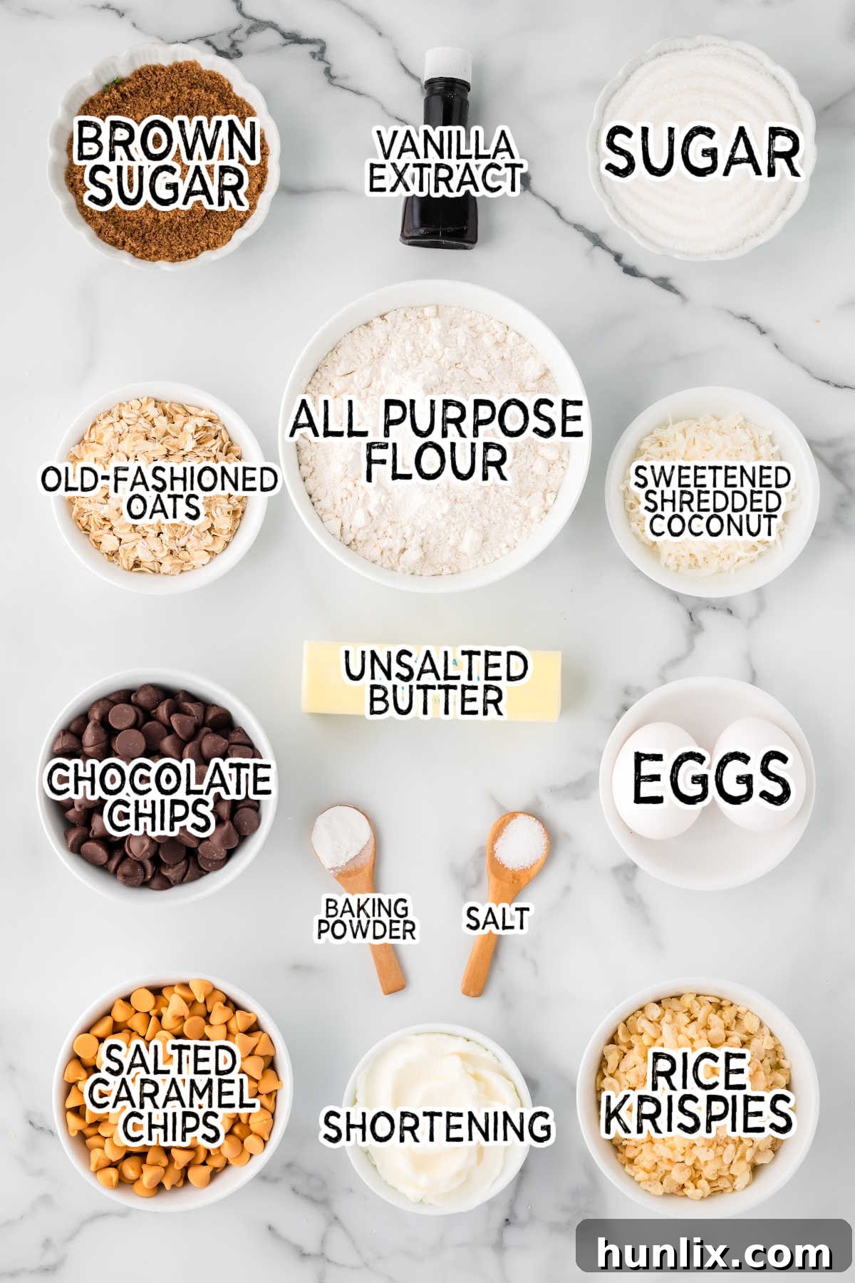 A vibrant display of all the necessary ingredients for baking Rice Krispie cookies, neatly arranged on a pristine white marble countertop.