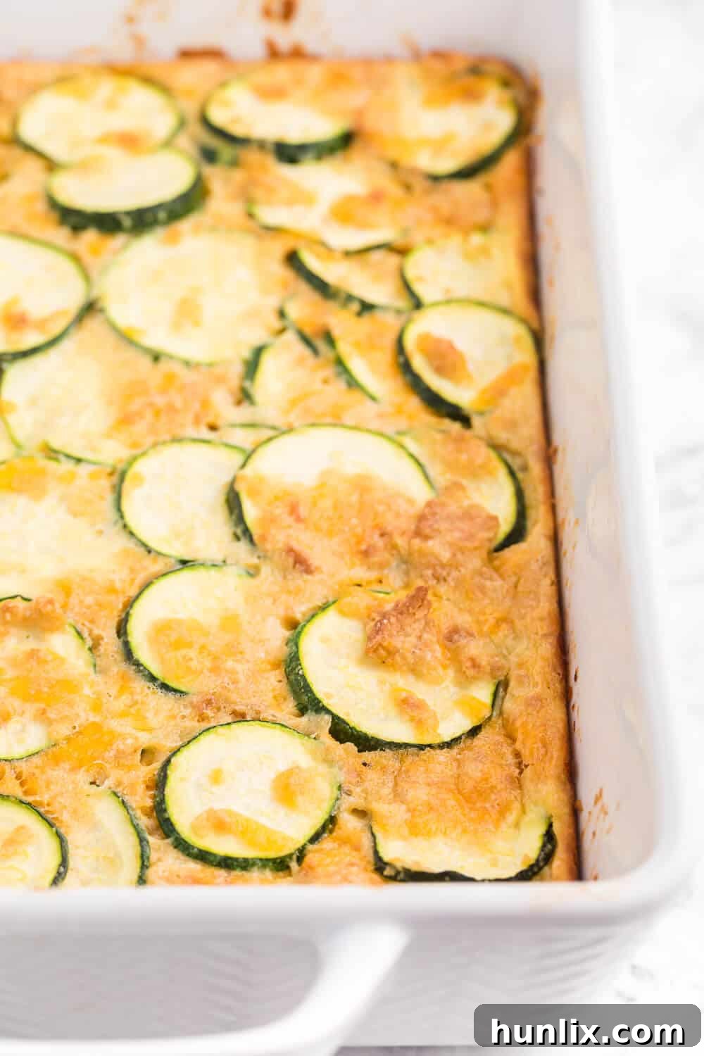 Golden Baked Zucchini 3 Baked Zucchini - An egg-based casserole with roasted zucchini slices, buttery crushed Ritz crackers and loads of cheese.