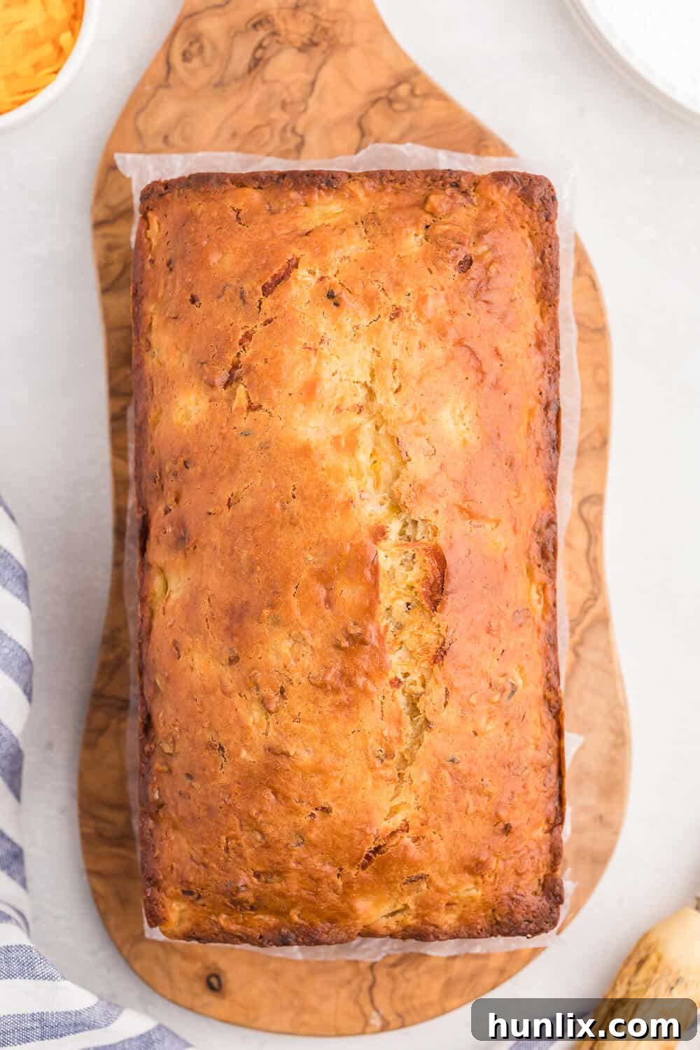 A slice of Pineapple Cheese Bread showing moist texture and pineapple chunks