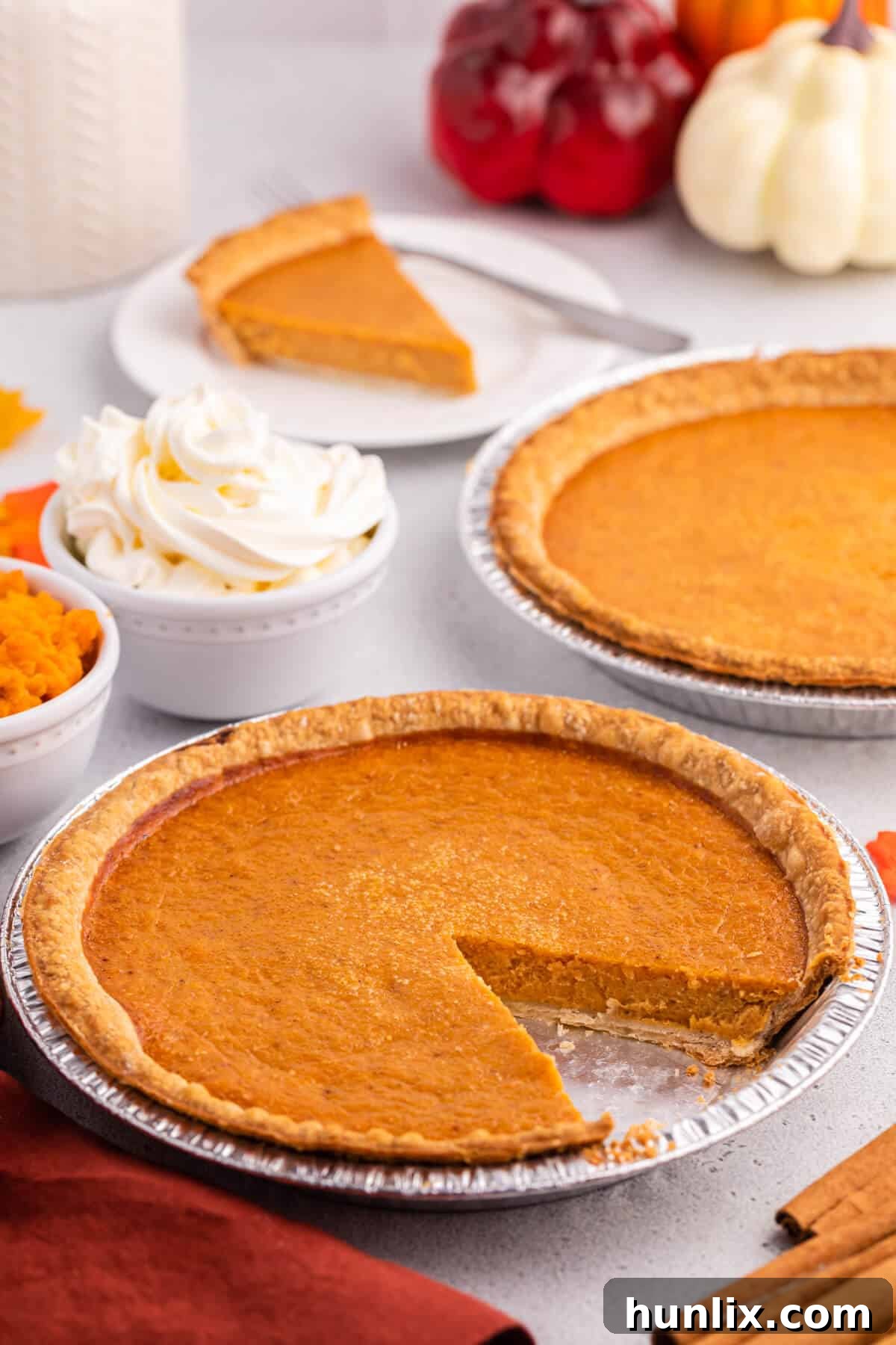 A perfectly baked sweet potato pie with a slice carefully cut out, showcasing its creamy texture.