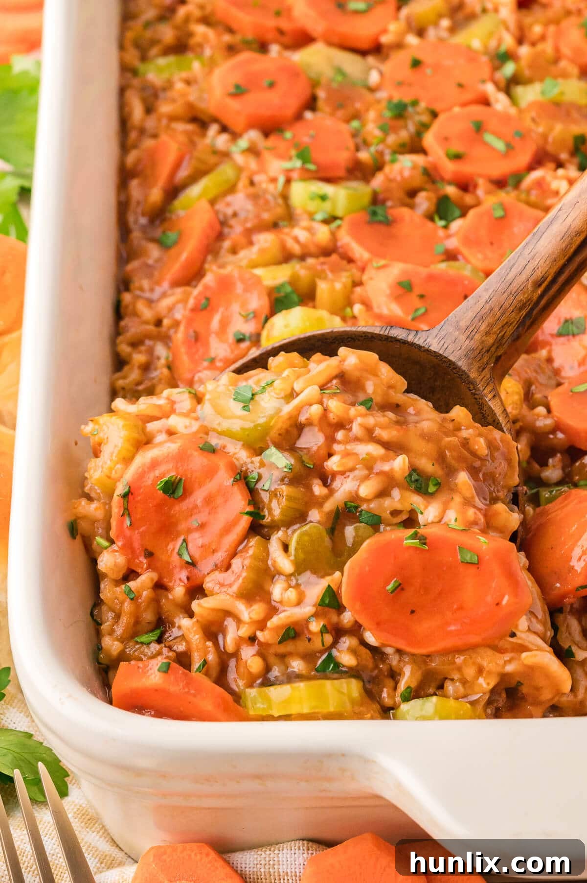 Castaway's Feast 2 A Shipwreck Casserole in a baking dish, ready to be served with a wooden spoon.