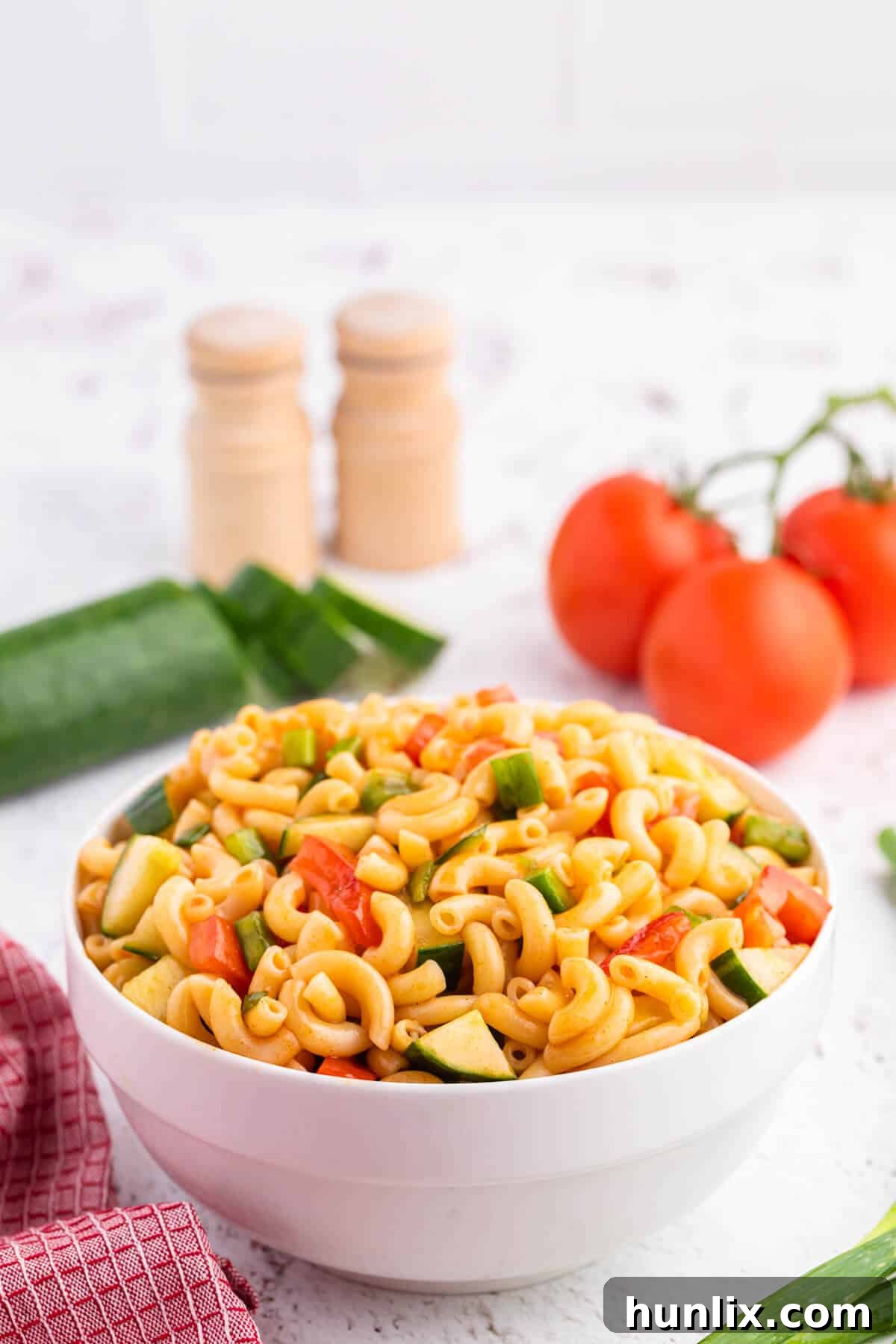 Creamy Pasta Delight 3 Close-up of the flavorful Macaroni Salad, showcasing the perfect blend of pasta and fresh, colorful vegetables coated in the light, sweet and tangy dressing.
