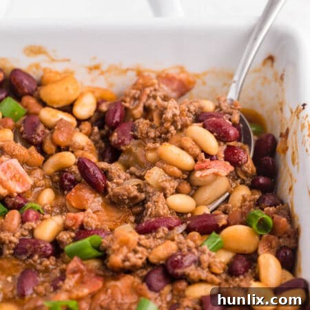 The casserole with a serving spoon.