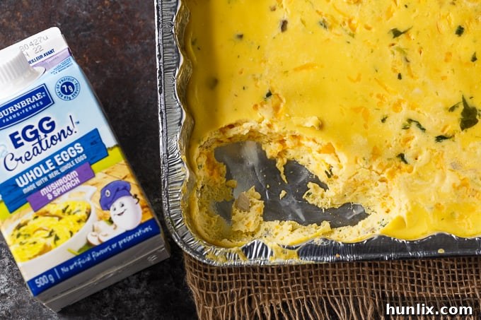 A close-up shot of shredded cheddar cheese, perfectly prepared and portioned for adding to the BBQ Eggs recipe, emphasizing quality and convenience for camping meals.