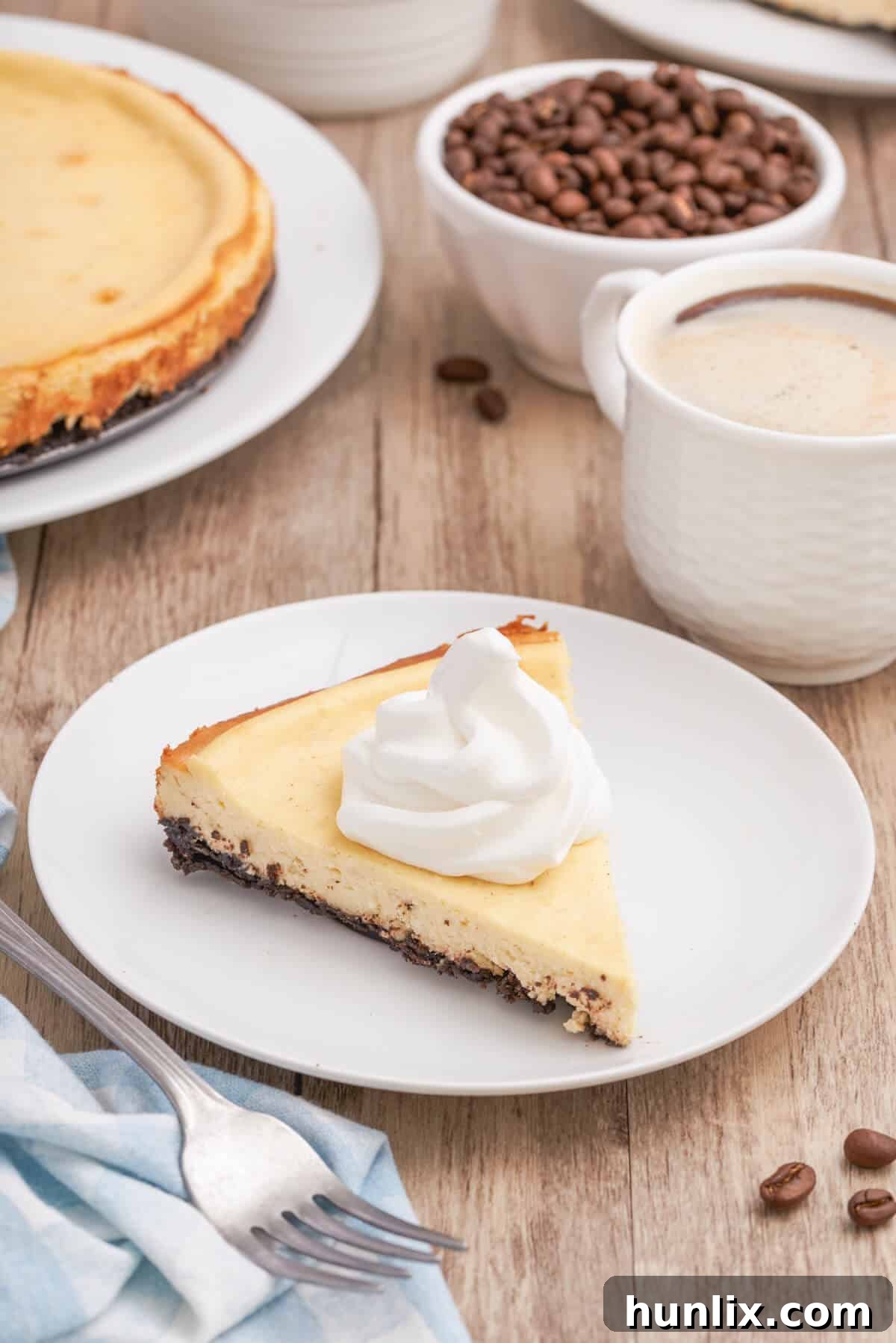 A slice of cappuccino cheesecake on a white plate, ready to be enjoyed.