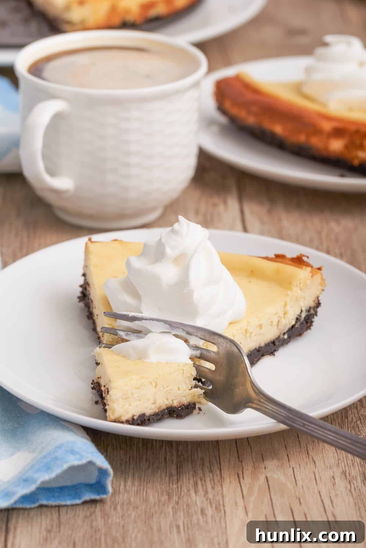 A slice of cappuccino cheesecake on a plate with a fork and a piece removed, highlighting its creamy texture.