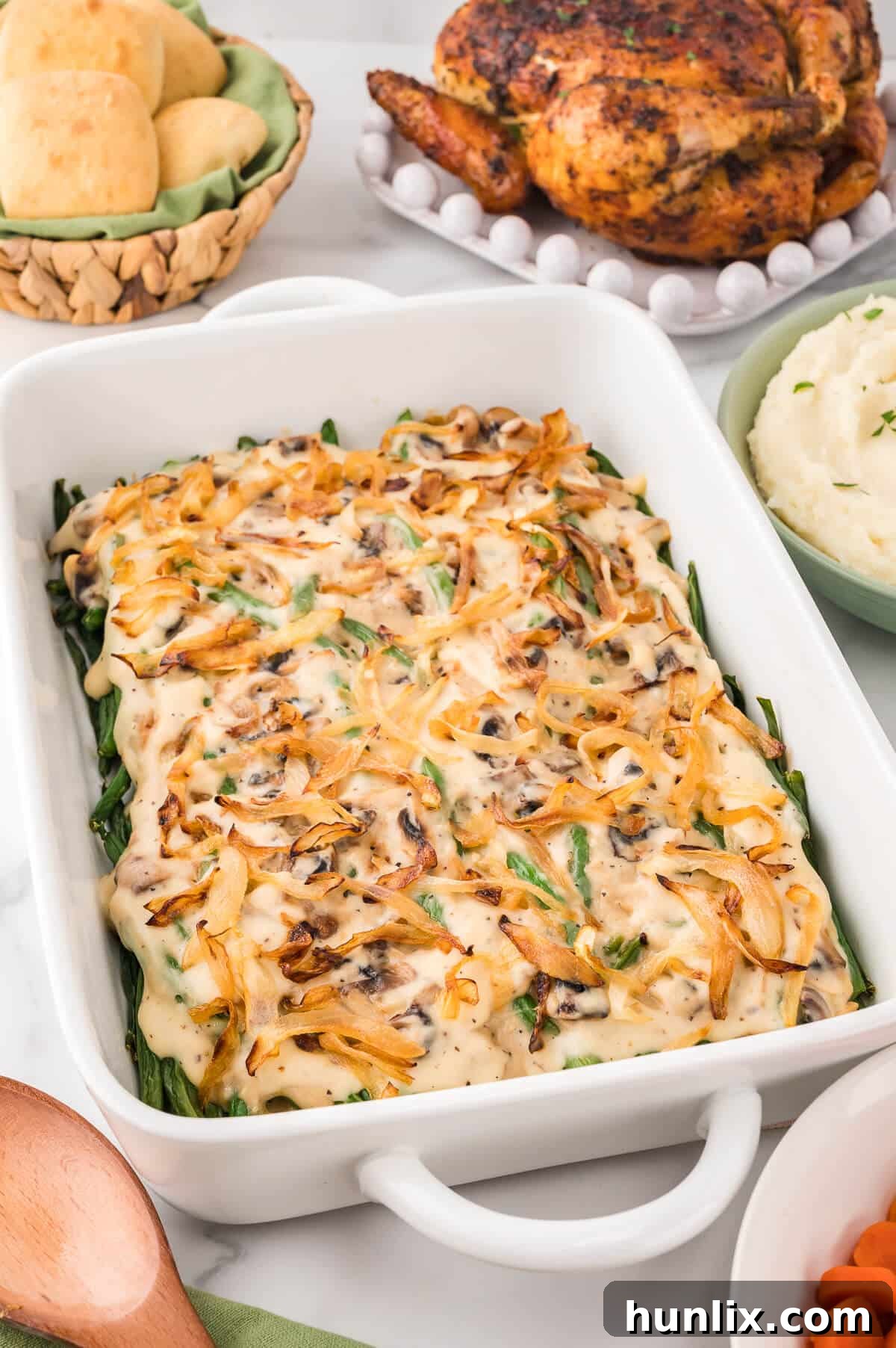 Homestyle Green Bean Bake 7 A close-up shot of the homemade green bean casserole in a white baking dish, showing its creamy texture and golden topping.