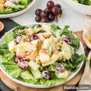 A delightful plate of Waldorf salad, generously portioned and elegantly served, ready to be enjoyed.