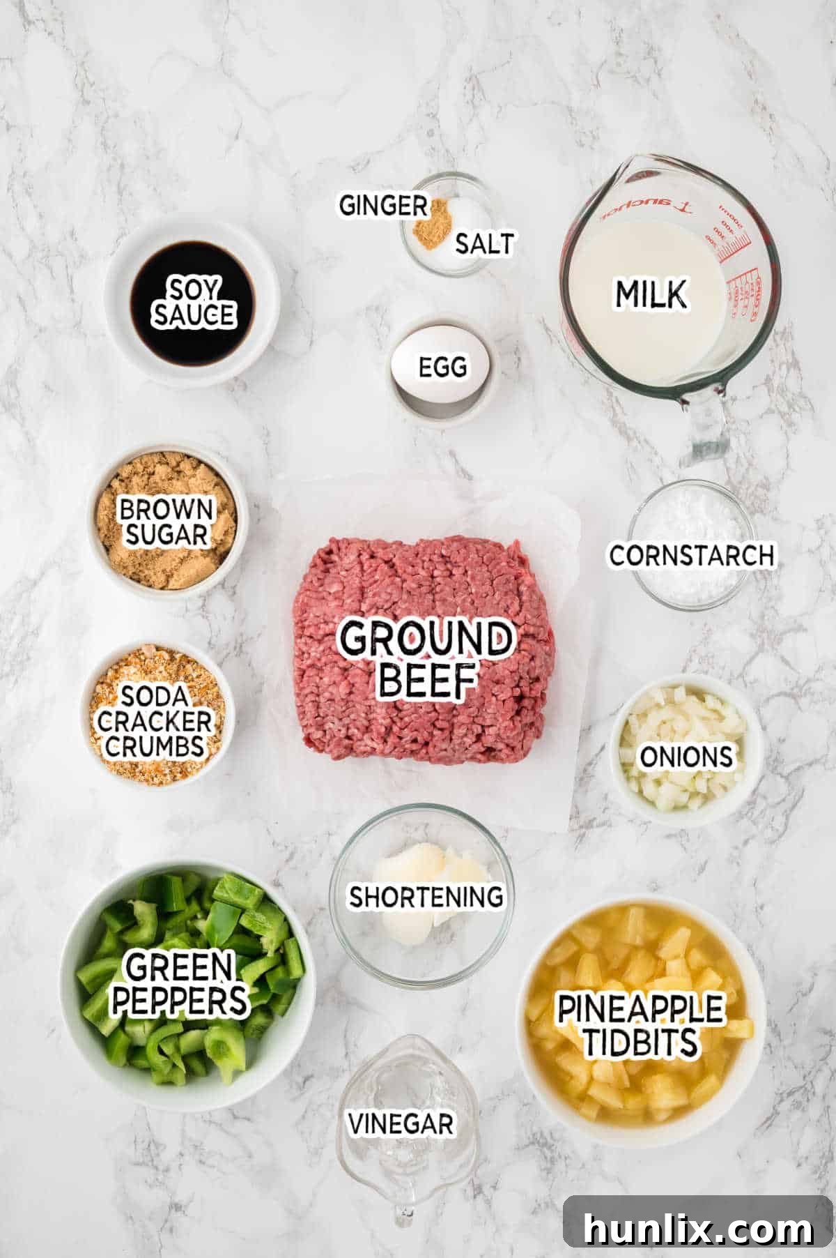 Various ingredients laid out on a white surface, ready to be used for making Waikiki Meatballs.