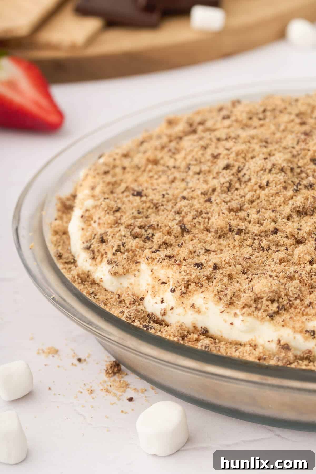 A beautifully set Marshmallow Pie in a pie pan, ready to be served, highlighting its fluffy texture and golden-brown crust.
