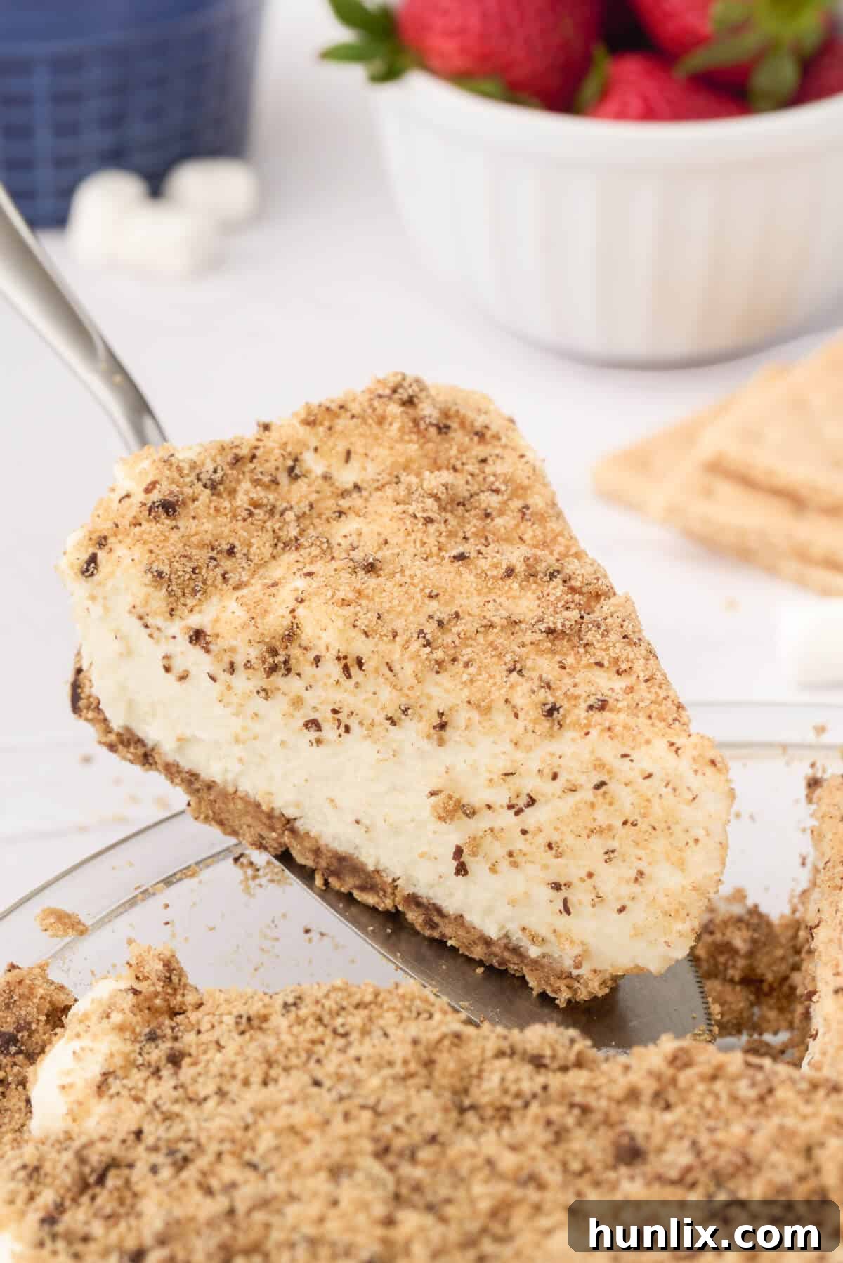 A delectable slice of Marshmallow Pie being lifted from the pan with a spatula, showcasing its layers of creamy filling and crunchy crust, ready to be enjoyed.