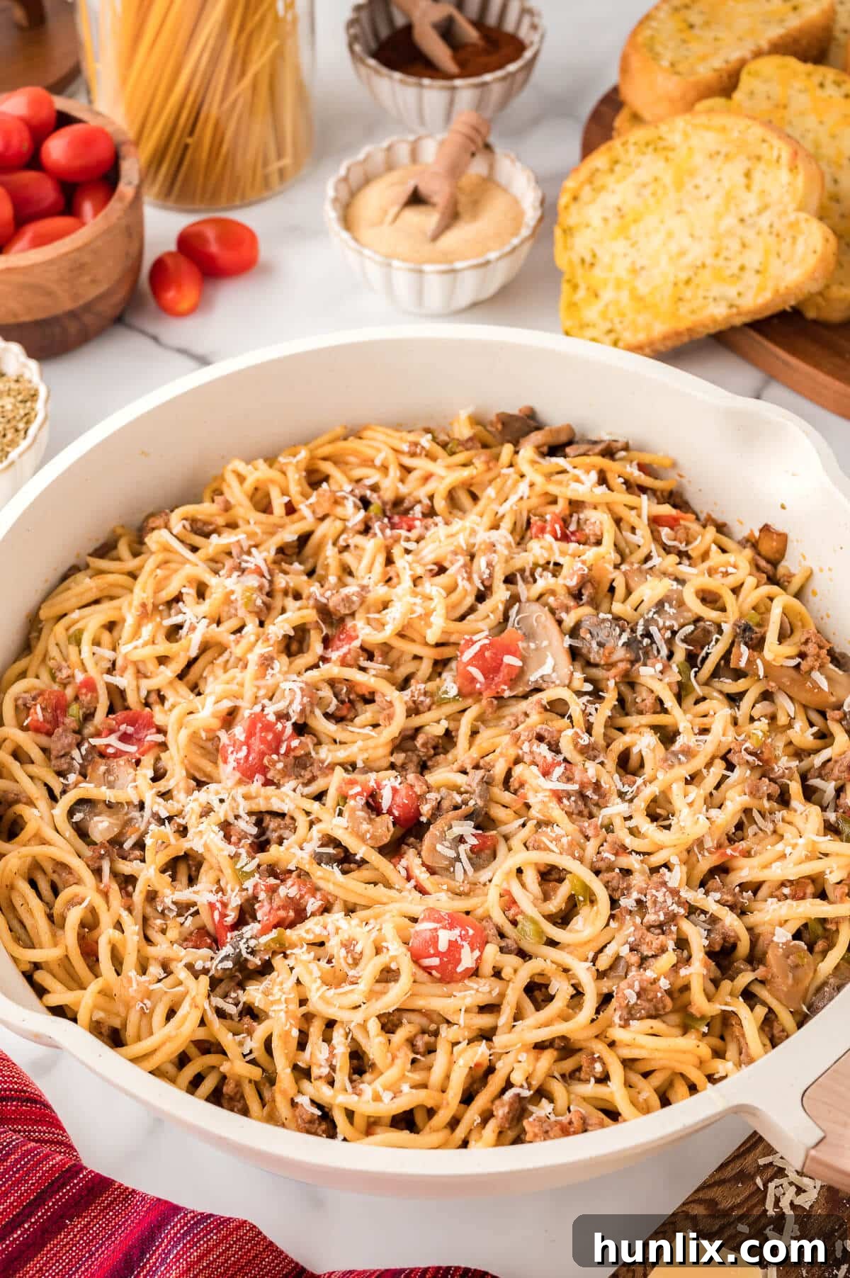 Easy Skillet Spaghetti 6 A serving of one-pan spaghetti in a white bowl, garnished with fresh parsley.