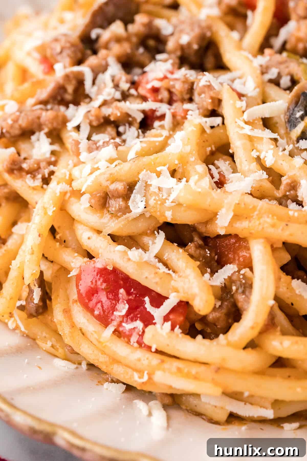 Easy Skillet Spaghetti 7 A close-up shot of one-pan spaghetti plated and ready to eat, garnished with parsley.