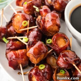 Bacon wrapped water chestnuts on a serving platter.