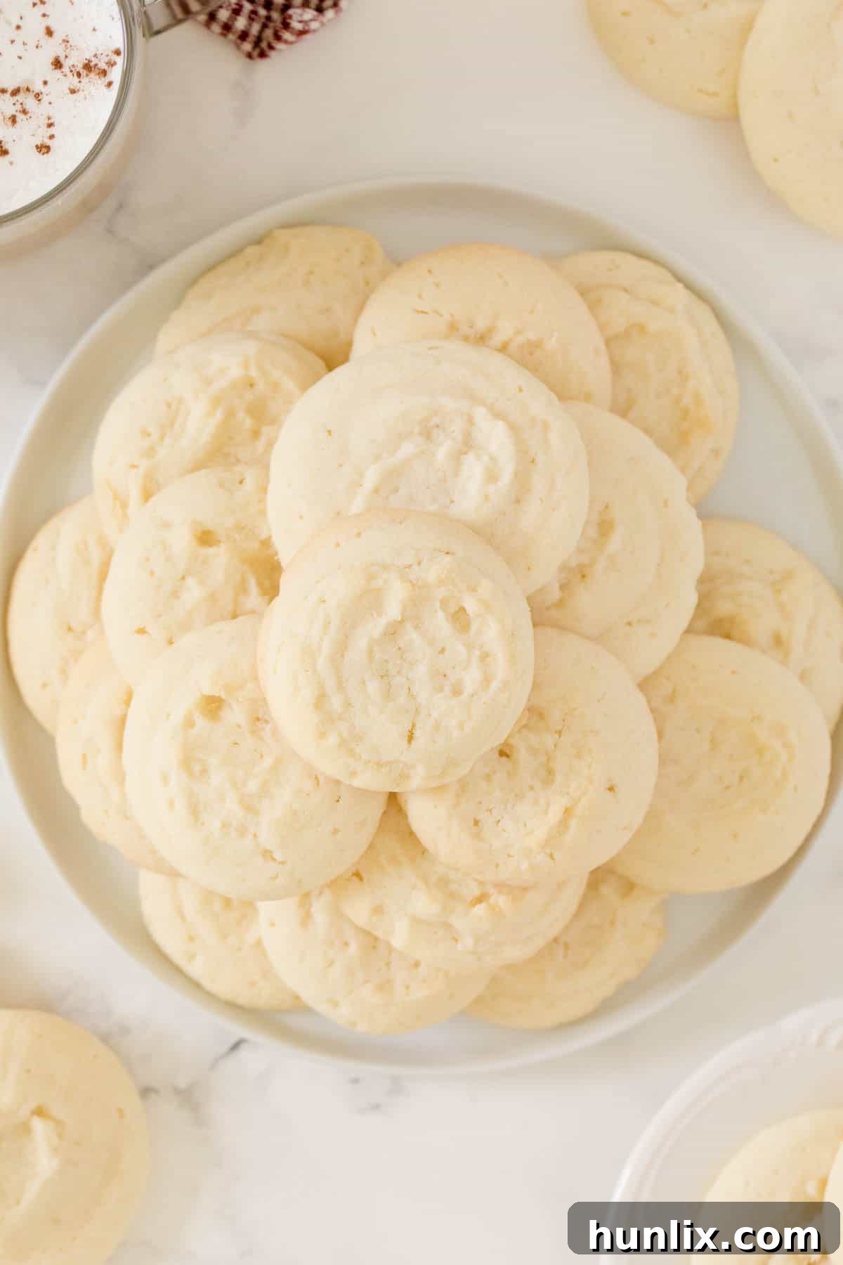 A beautifully arranged plate of whipped shortbread cookies, showcasing their golden edges and delicate appearance.