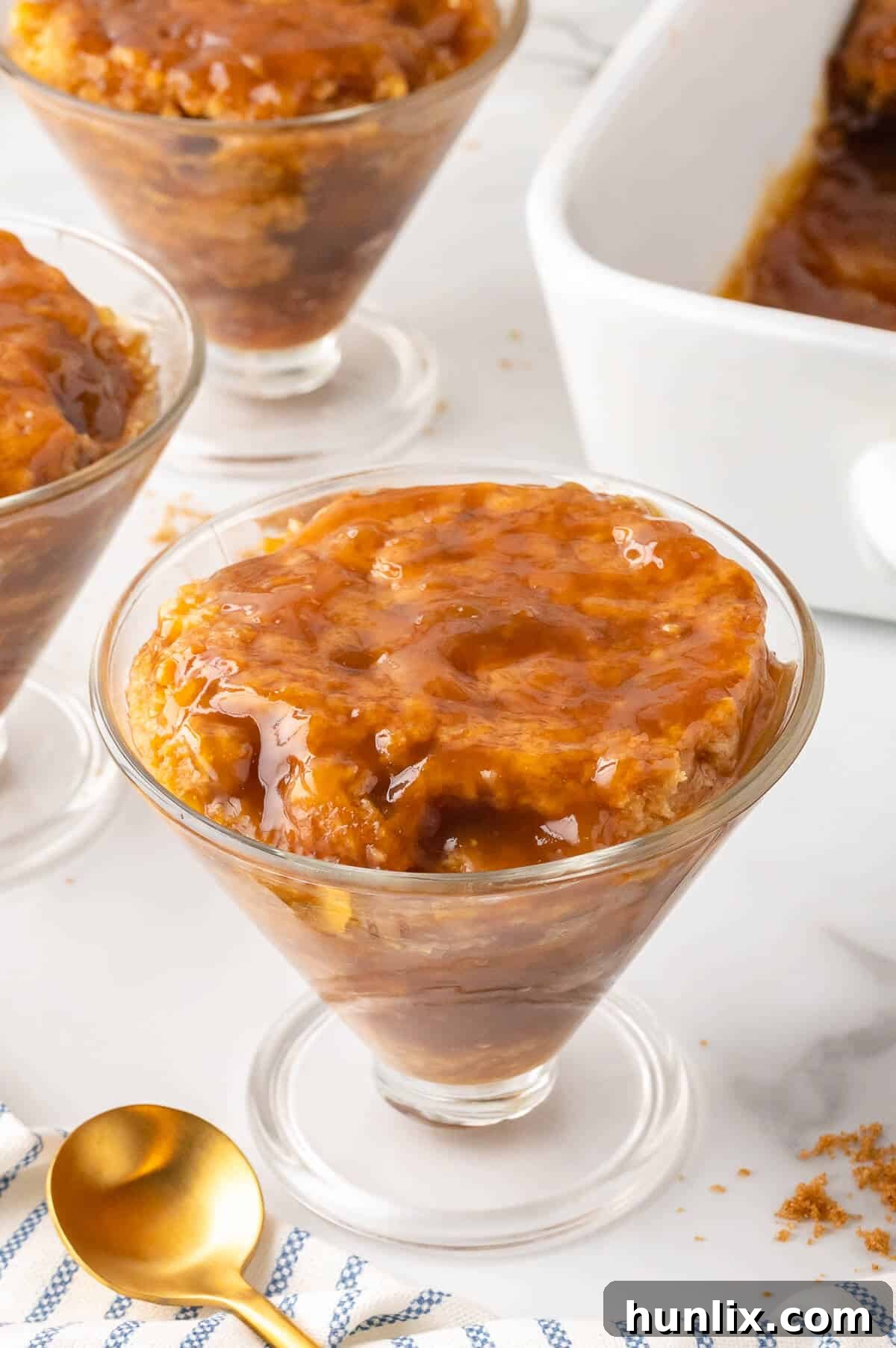 A single serving of Half-Hour Pudding in a dessert dish, topped with a scoop of ice cream.