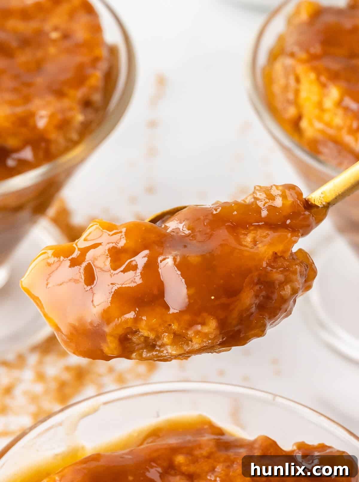 A spoonful of Half-Hour Pudding with visible caramel sauce and cake, ready to be eaten.