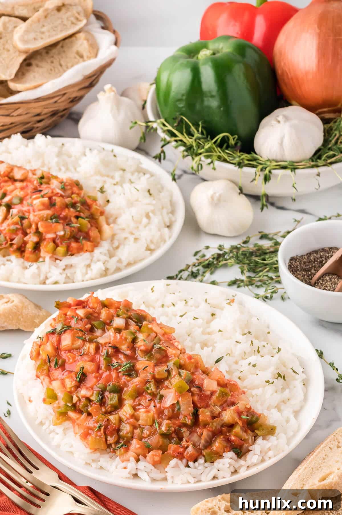 The recipe on a bed of rice on a plate.