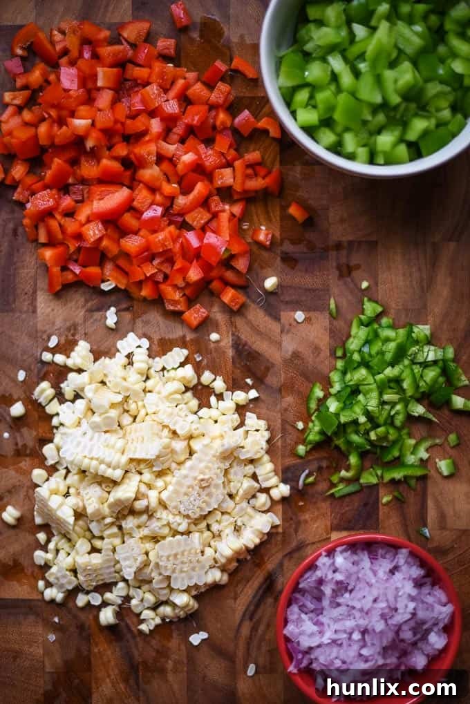 Hearty Vegan Mexican Casserole layers with fresh vegetables, refried beans, and melted vegan cheese, ready to be served.