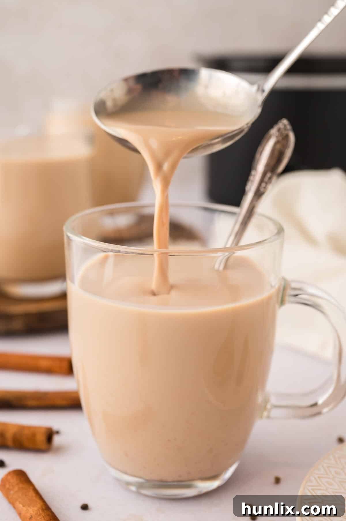A ladle pouring the recipe into a glass mug.