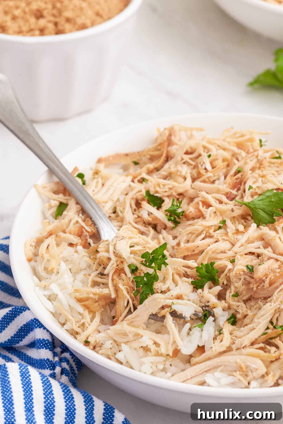 Sticky Sweet Brown Sugar Chicken 7 A close-up of Brown Sugar Chicken in a bowl with a fork, ready to eat.