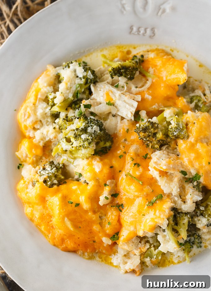Keto Chicken Divan Bake 3 A close-up view of the creamy texture of Low Carb Chicken Divan, showcasing the chicken, broccoli florets, and cauliflower rice in a rich sauce.