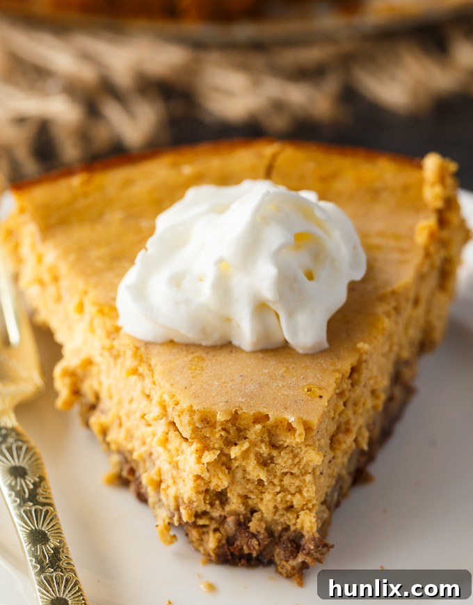 Overhead shot of a full Keto Pumpkin Cheesecake, garnished and ready.