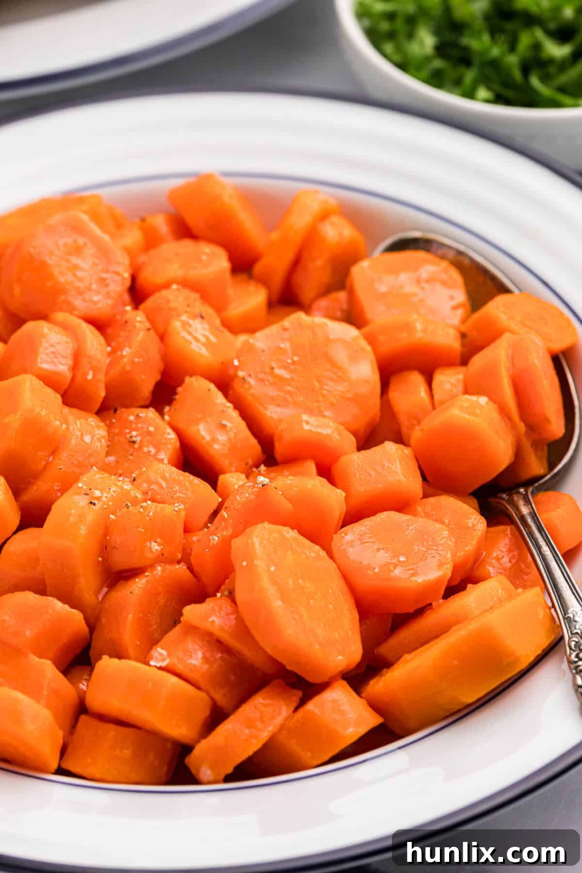 Sweet and sour carrots in a bowl with a spoon.