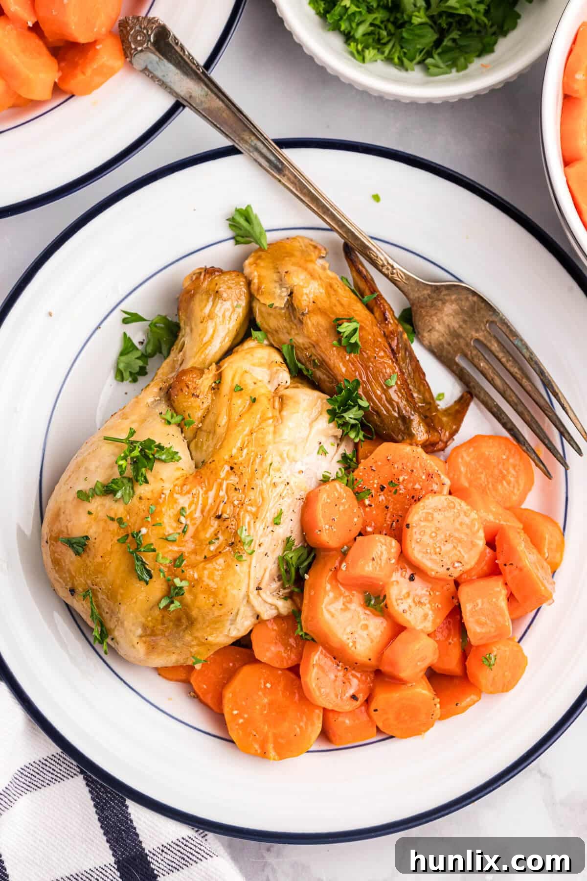 Sweet and sour carrots on a plate with chicken.