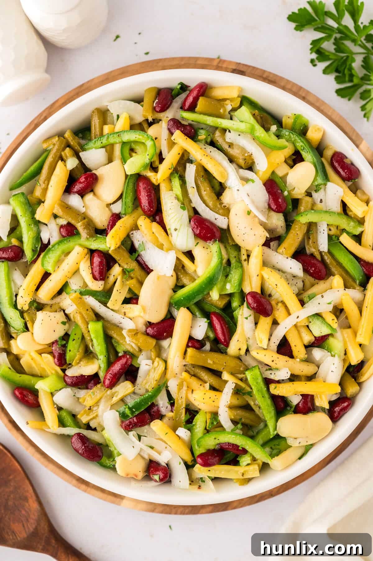 Vibrant Bean Medley 2 A colorful bean salad served in a large, inviting bowl, garnished with fresh herbs, perfect for sharing at a summer potluck or family meal.