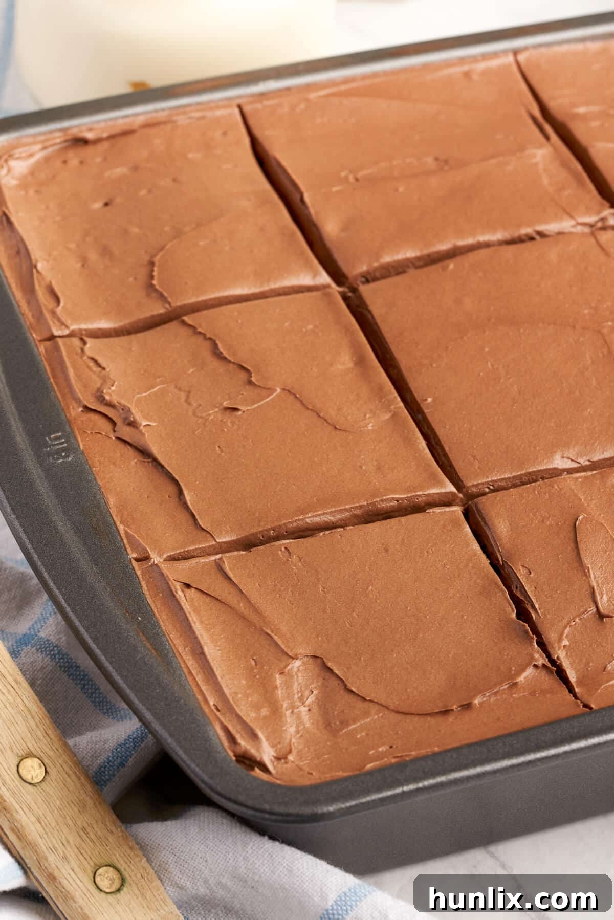 Mayonnaise cake in a pan with slices cut.