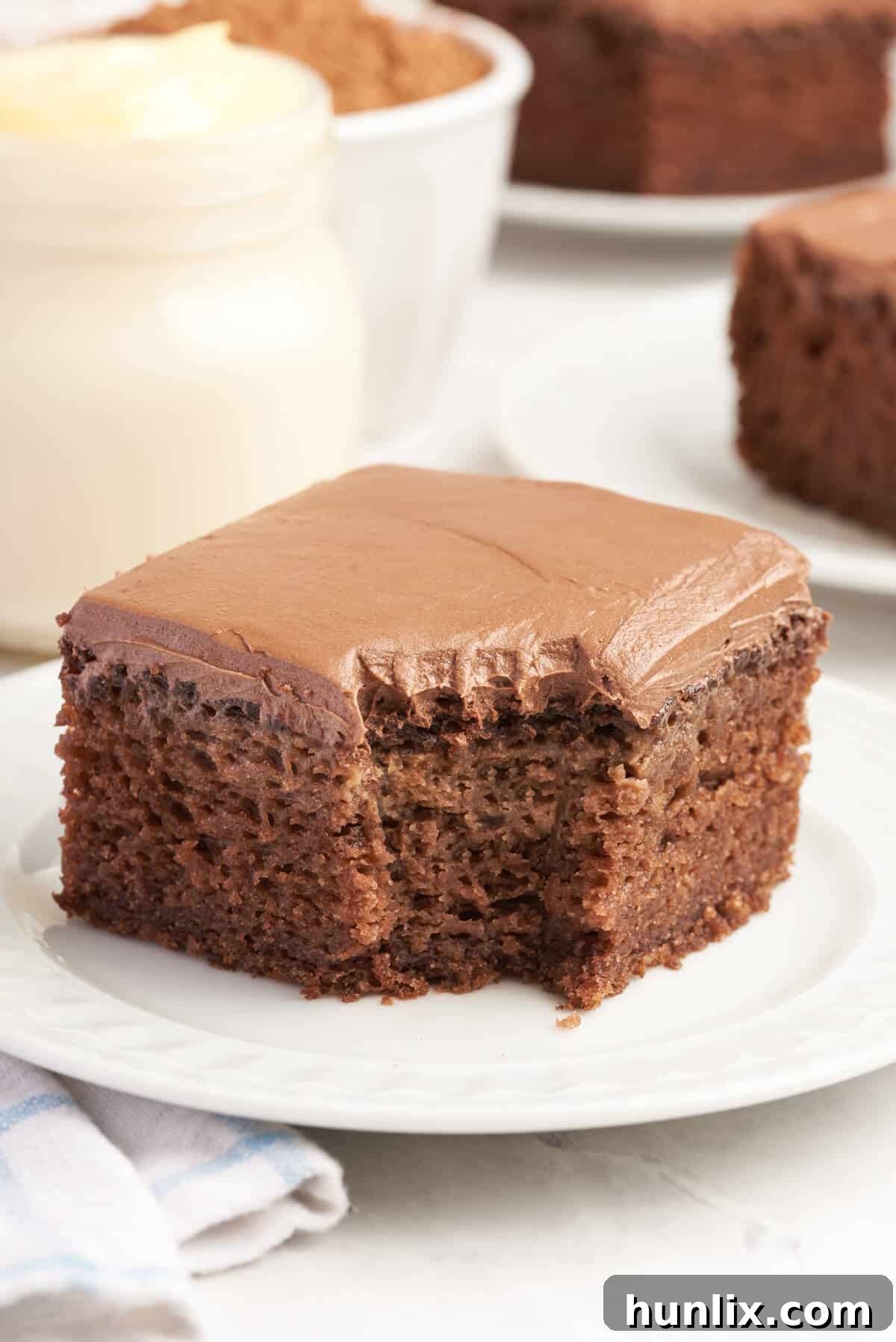 A piece of cake on a plate with a bite out of it.