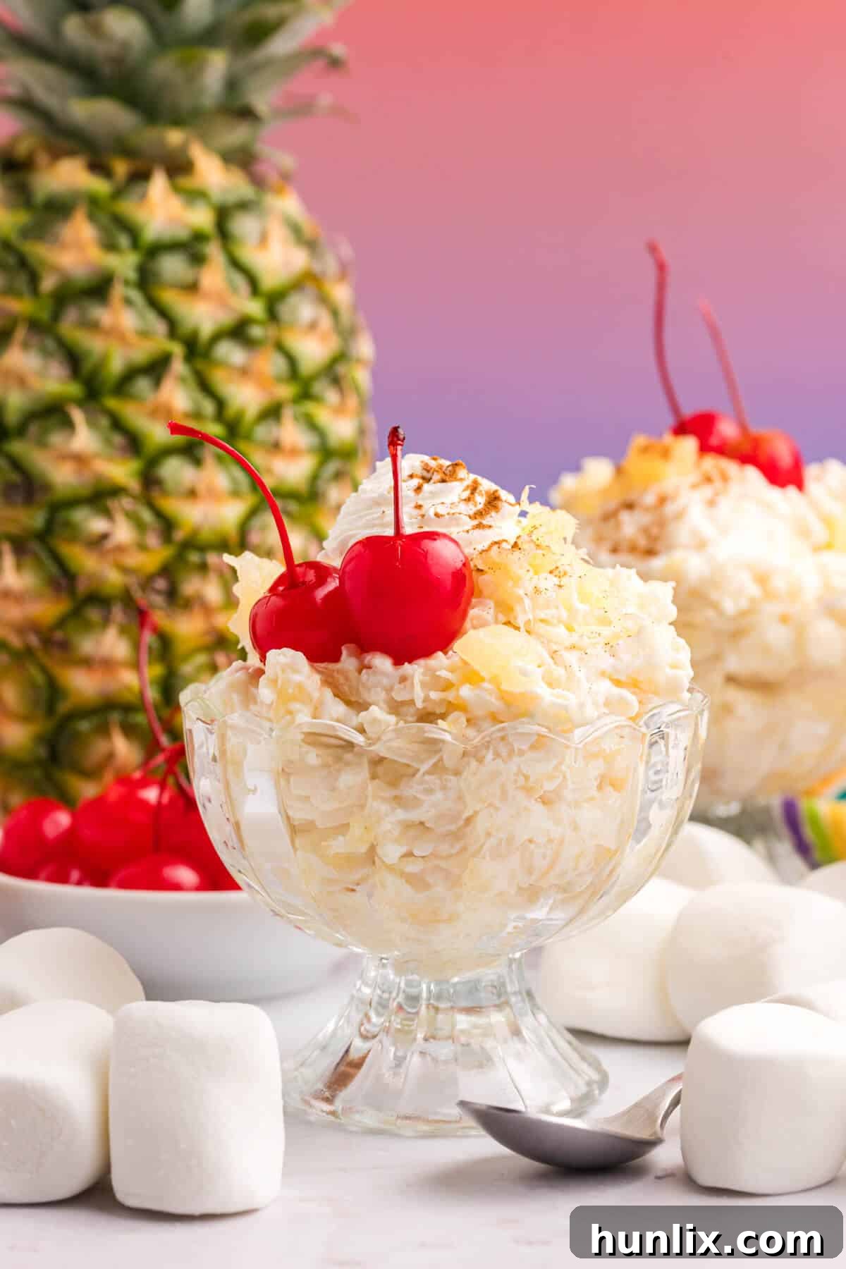 A close-up of pineapple rice pudding in a glass dish, showing its creamy texture and pineapple chunks.