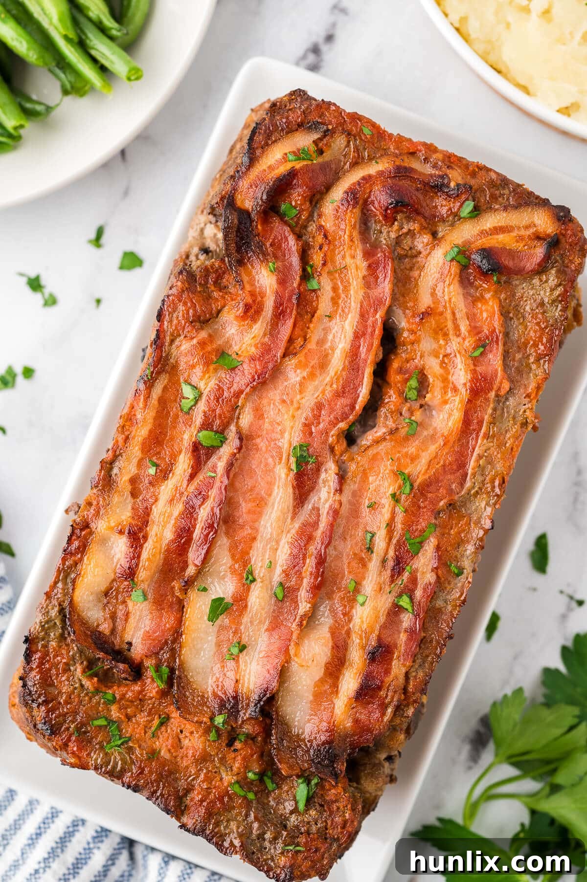 Sunday's Best Meatloaf 2 Perfectly cooked Sunday meatloaf on a platter, ready to be sliced and served.