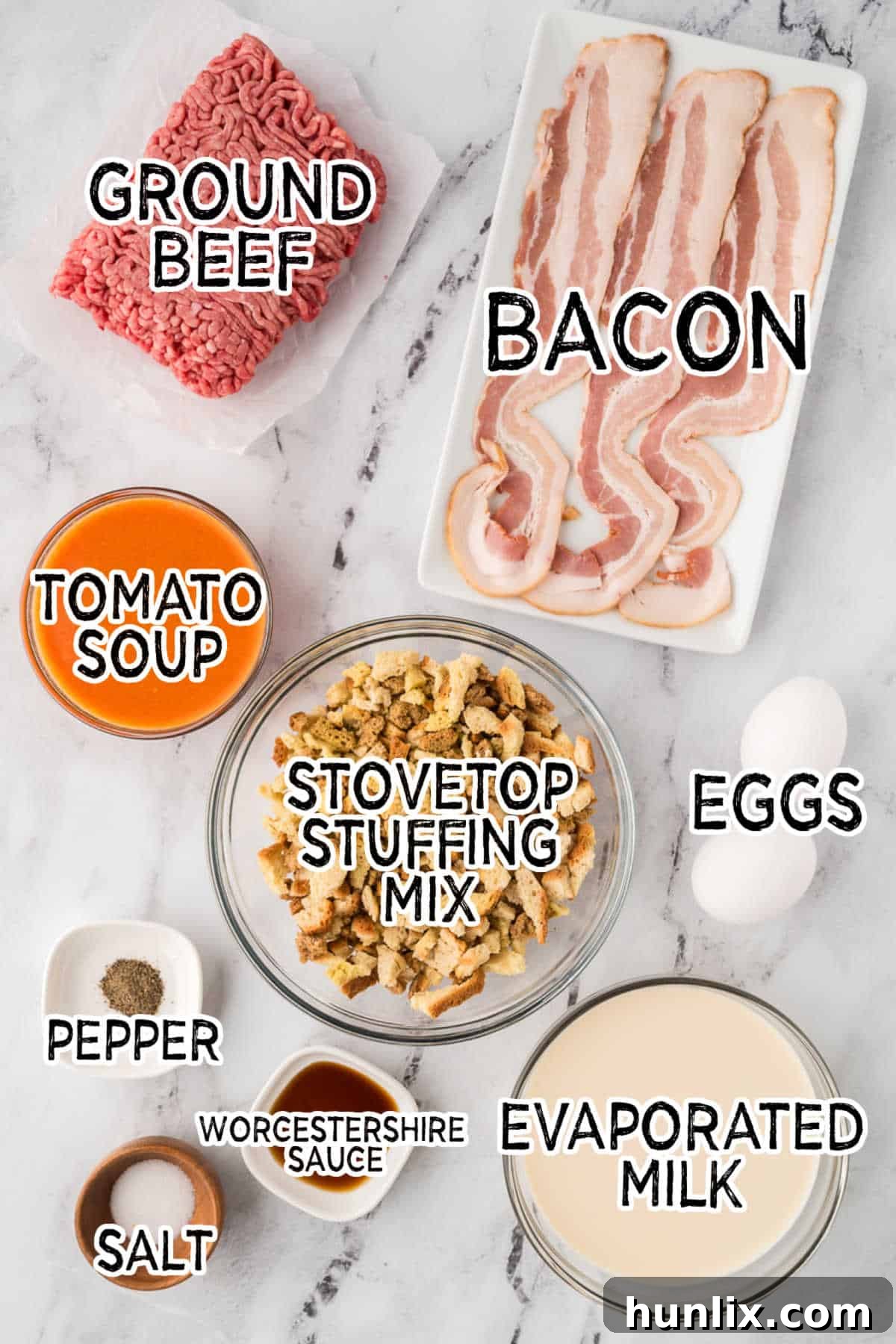 Sunday's Best Meatloaf 3 Arrangement of Sunday meatloaf ingredients: ground beef, eggs, seasonings, milk, stuffing mix, tomato soup, and bacon.