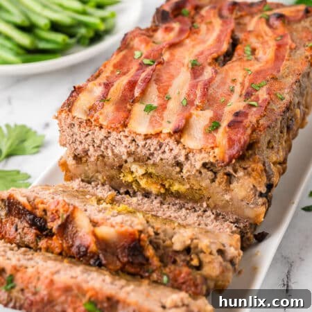 Sunday meatloaf on a platter with slices cut off the end.
