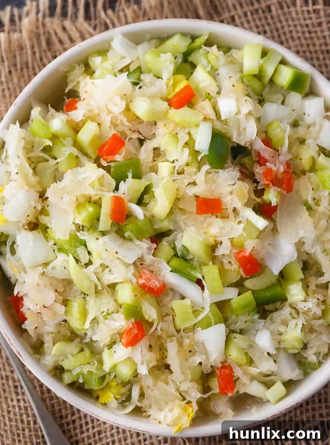 Sauerkraut Salad - Tangy and sweet! This delicious salad recipe has crisp veggies, sauerkraut tossed in a sweet dressing. Delish!
