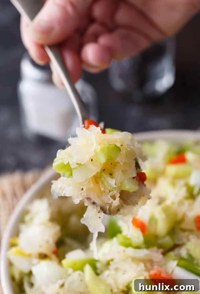 Sauerkraut Salad - Tangy and sweet! This delicious salad recipe has crisp veggies, sauerkraut tossed in a sweet dressing. Delish!