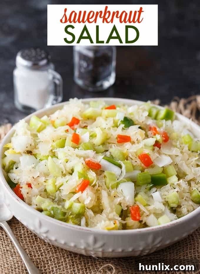 Sauerkraut Salad - Tangy and sweet! This delicious salad recipe has crisp veggies, sauerkraut tossed in a sweet dressing. Delish!