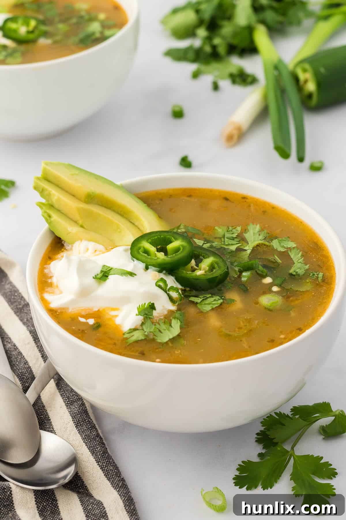 A beautifully presented bowl of white chicken chili, adorned with fresh garnishes like cilantro and sour cream, ready to be enjoyed.