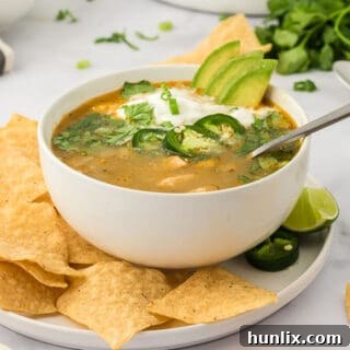 White chicken chili in a bowl with a spoon.