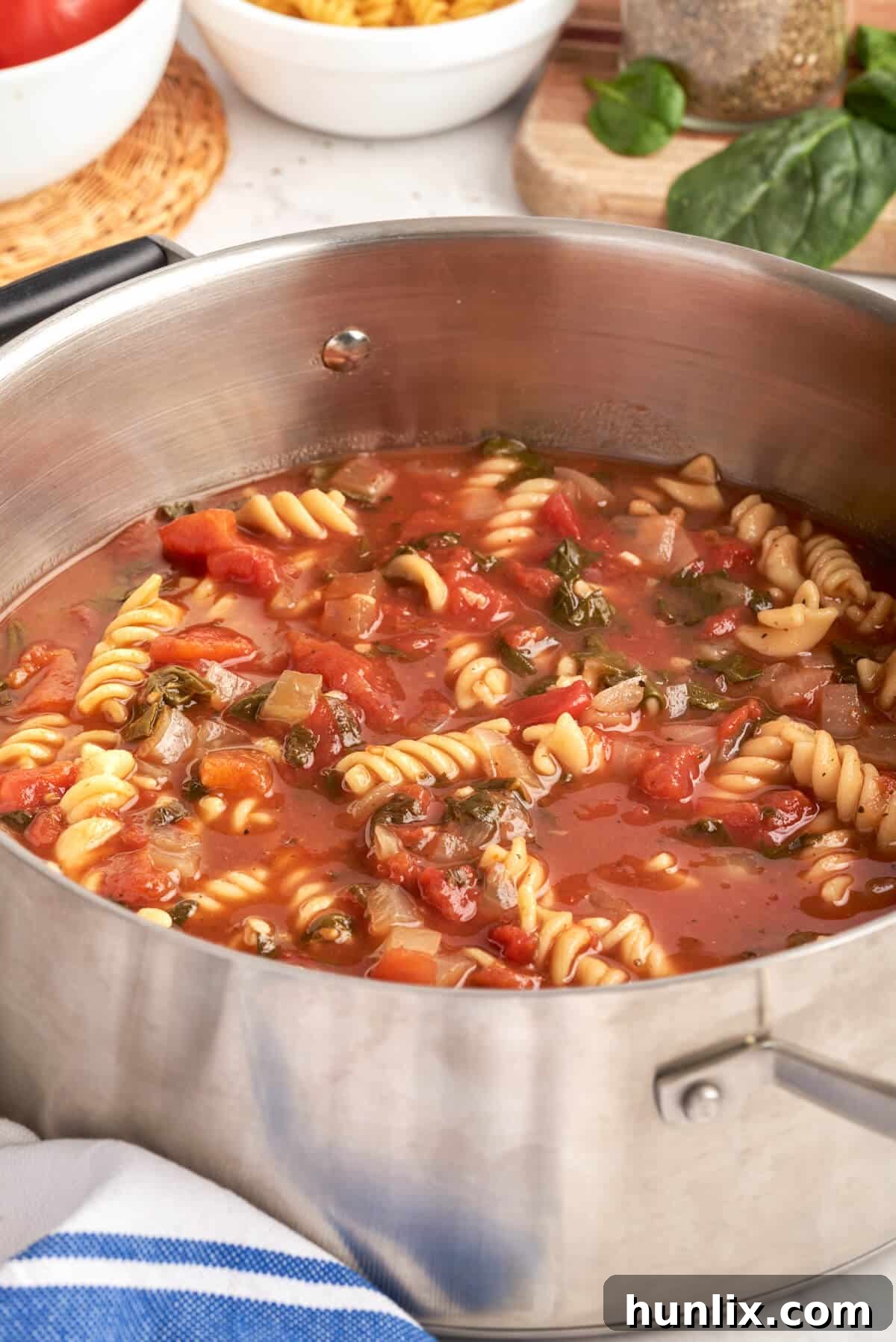 A pot of vibrant tomato florentine soup, ready to serve.