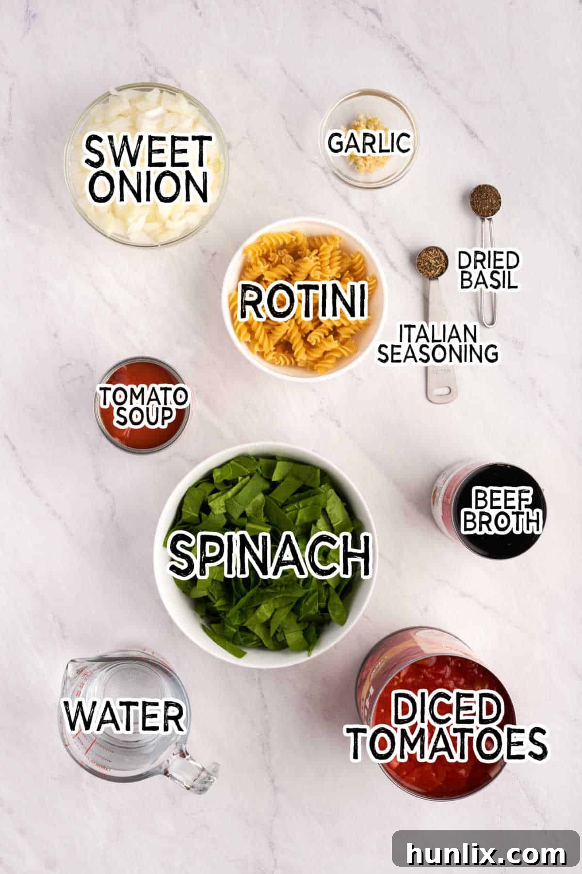 Fresh ingredients laid out on a white marble counter, ready for Tomato Florentine Soup.